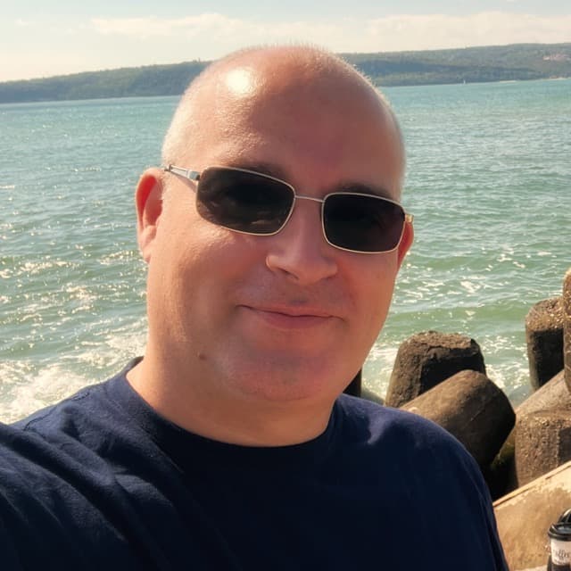 Atanas Atanasov smiling dressed in a green t-shirt